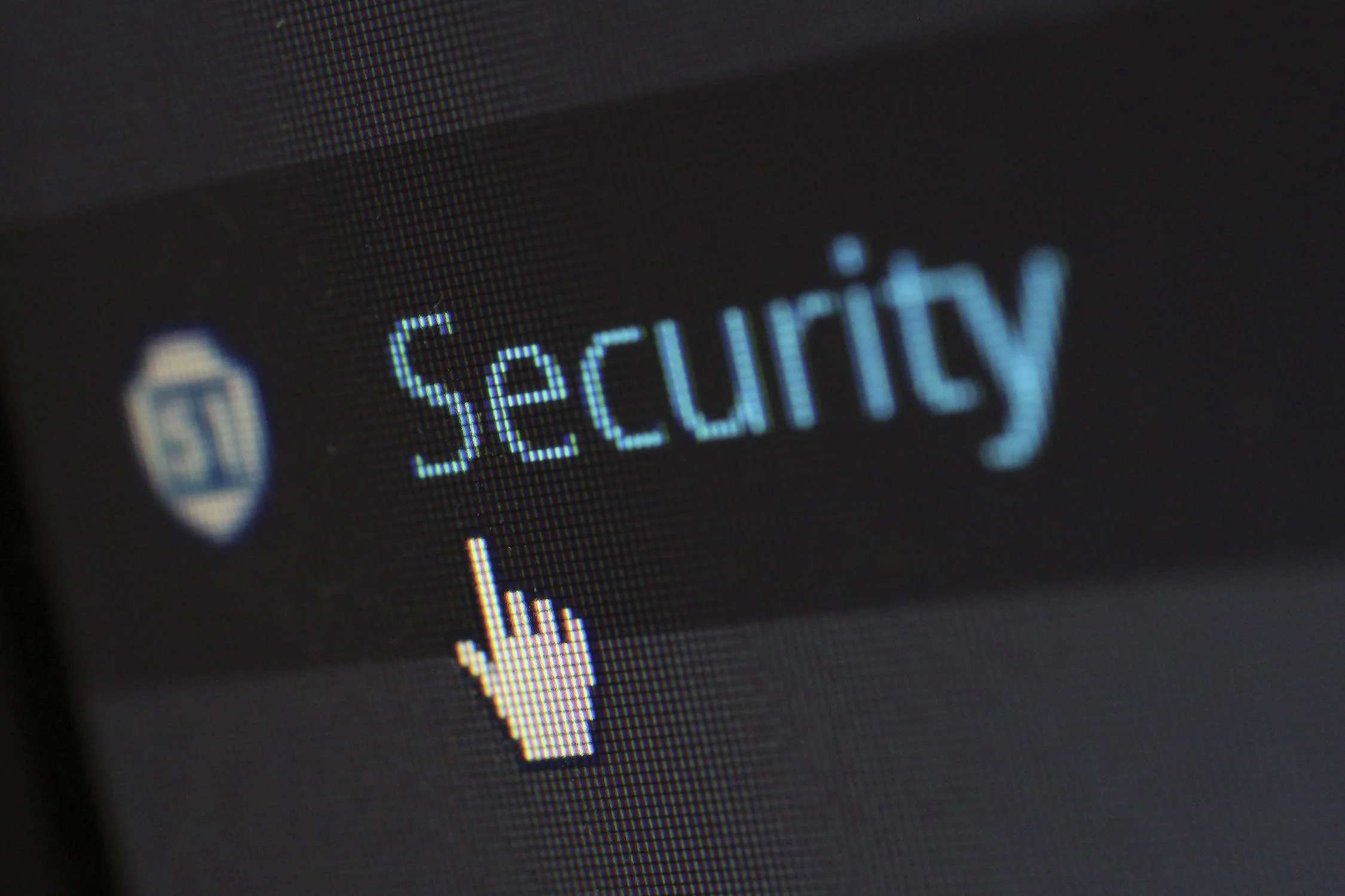 A digital white cursor hovering over the word security which is partially blurred out